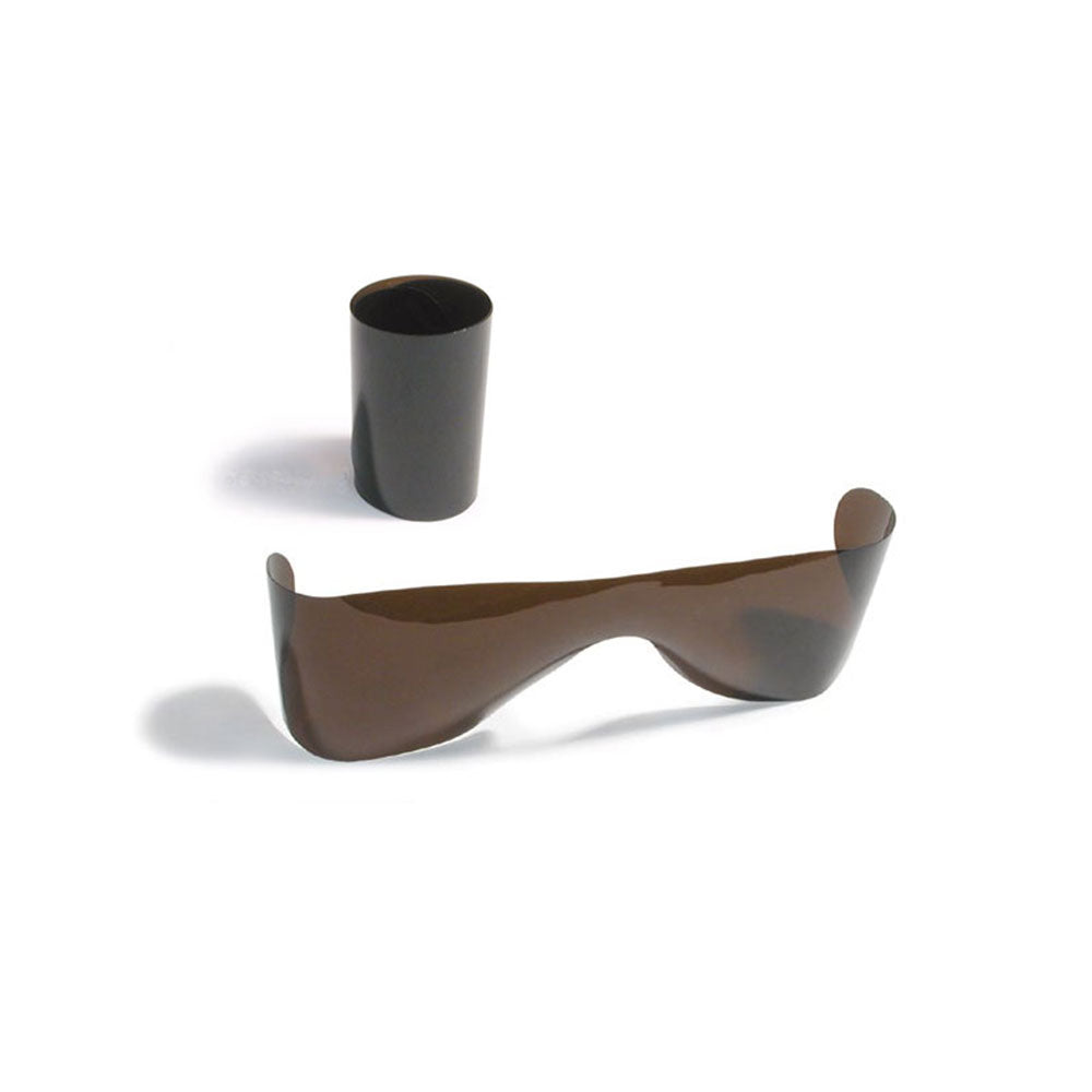 In the foreground, a flat, dark brown film resembling the Post Mydriatic Glasses-Rollups by MedPharma USA provides eye protection. Behind it, another piece stands rolled-up against a plain white backdrop, hinting at subtle UV shielding.